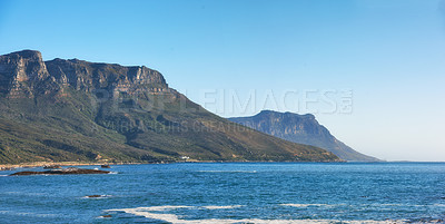 Buy stock photo Table mountain, ocean and travel on vacation, holiday location and mockup space for tourism. Sea, water and outdoor with blue sky, beach and rocks on coastal landscape in environment in South Africa