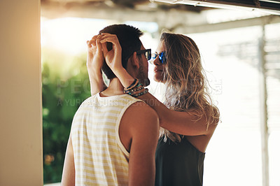 Buy stock photo Cropped shot of an affectionate young couple sharing an intimate moment outside on their balcony