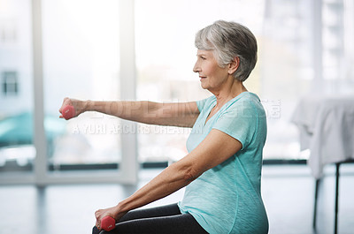Buy stock photo Cropped shot of a healthy senior woman working out with dumbbells