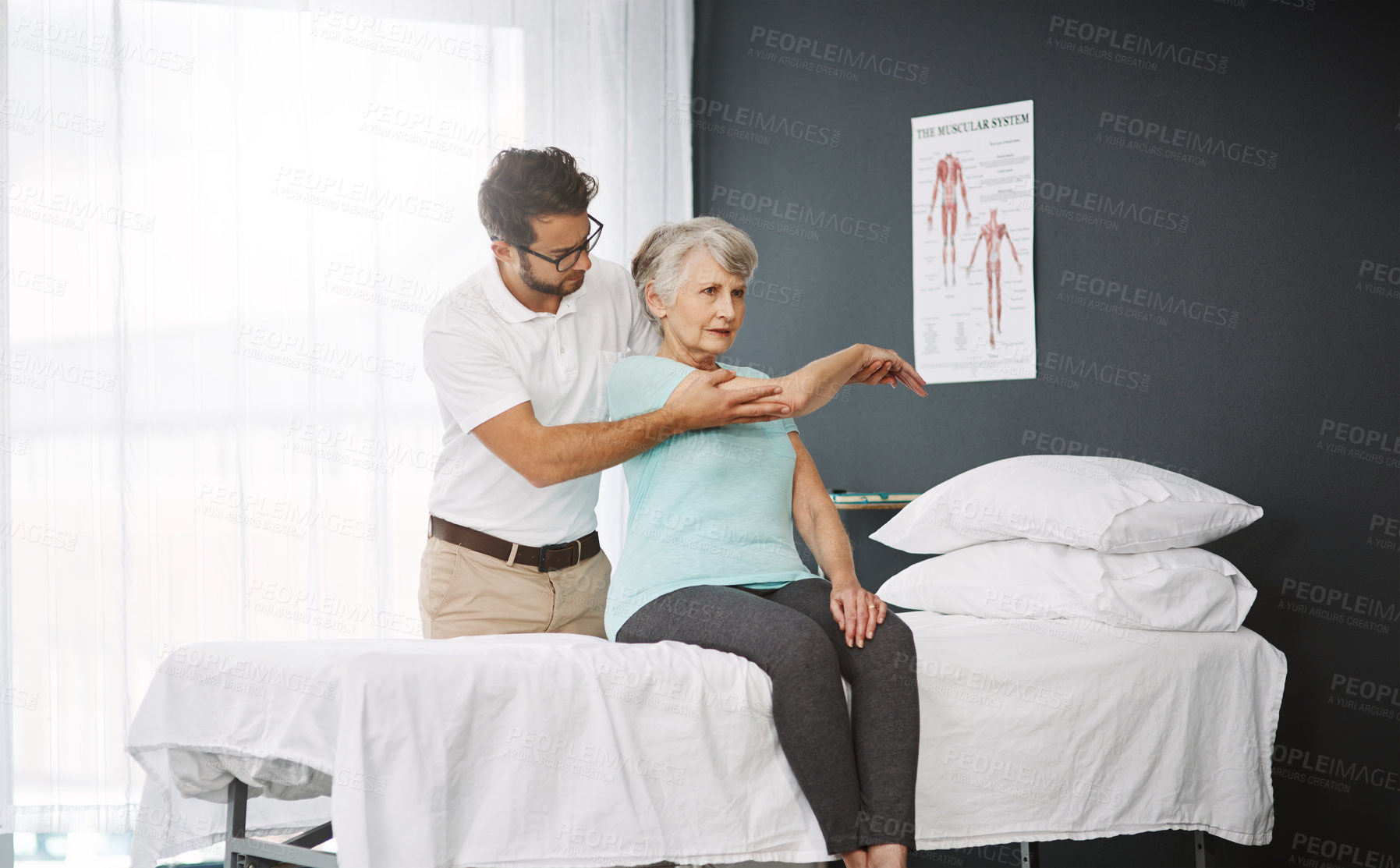 Buy stock photo Cropped shot of a young male physiotherapist working with a senior female patient