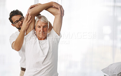 Buy stock photo Cropped shot of a young male physiotherapist working with a senior male patient