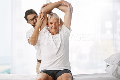 Buy stock photo Cropped shot of a young male physiotherapist working with a senior male patient