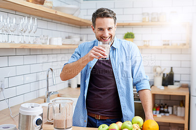 Buy stock photo Shot of a young man making a health smoothie at home