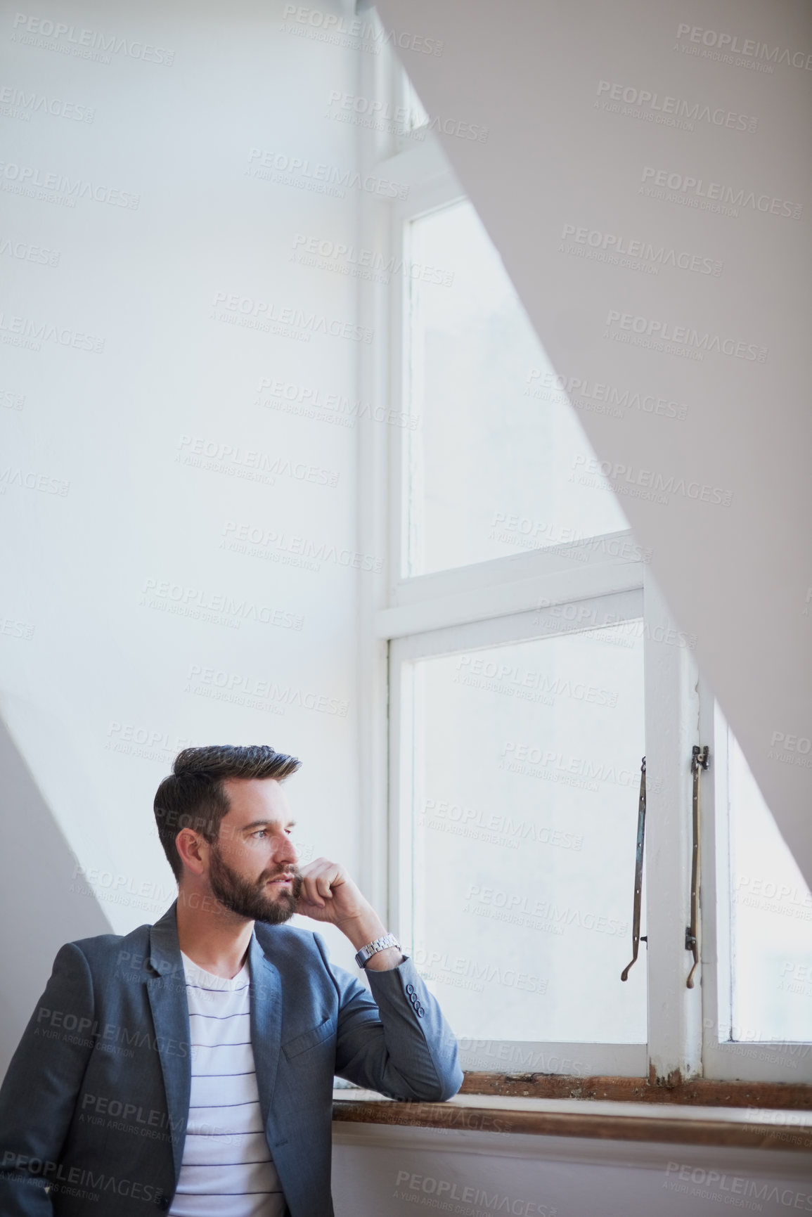 Buy stock photo Cropped shot of a handsome young businessman standing by his bedroom window
