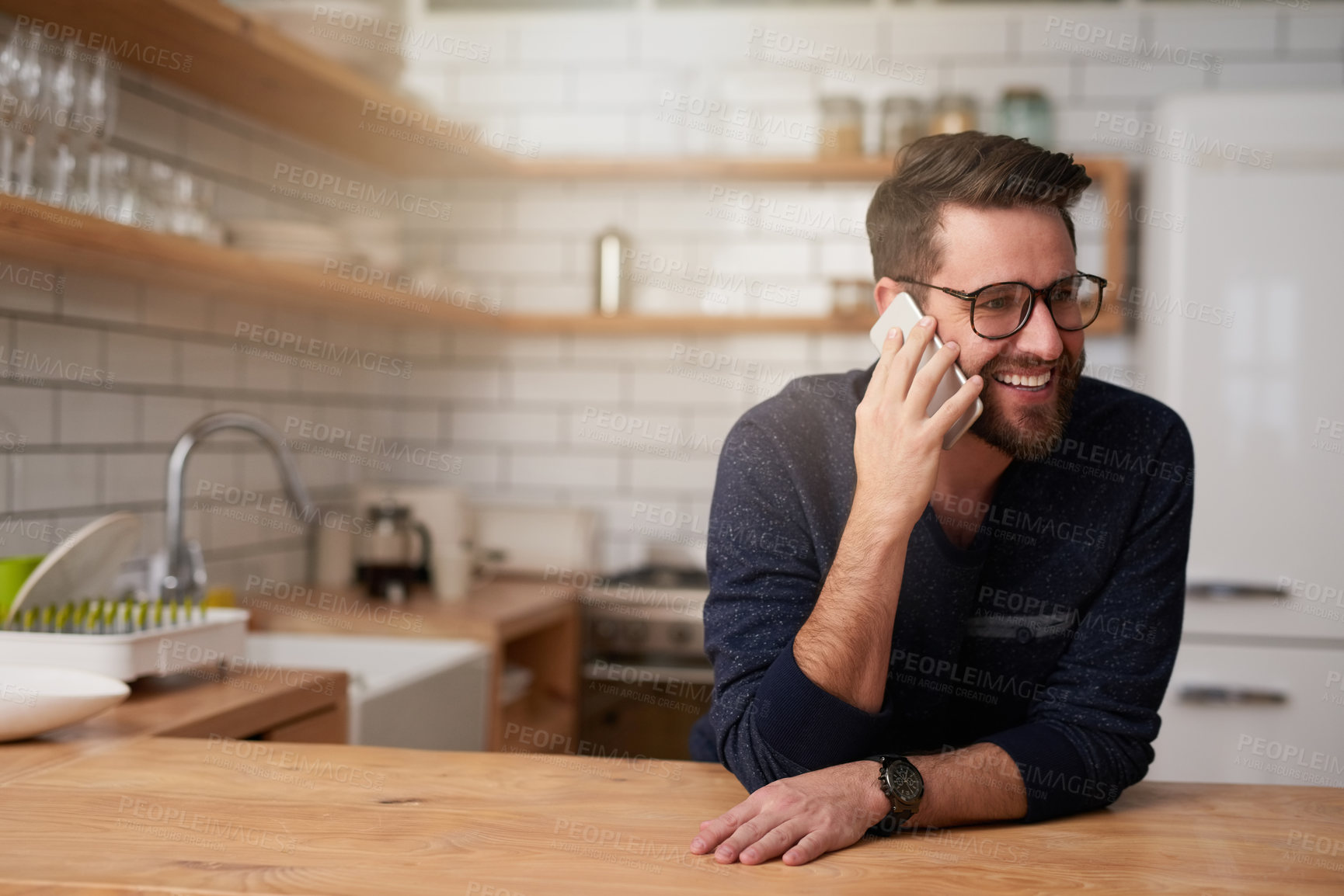 Buy stock photo Happy man, kitchen and phone call with discussion for business, proposal or chat at home. Young, male person or freelancer with smile for conversation or communication on mobile smartphone at house