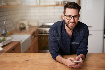 Buy stock photo Man, phone or portrait in kitchen for remote work, planning or schedule app for productivity in home. Creative writer, tech or smile at desk for brainstorming, connectivity or book review on internet