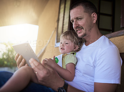 Buy stock photo Father, girl child and tablet on patio for reading, relax and happy for ebook, story or bonding at family home. Dad, daughter and touchscreen in backyard with streaming app, video or cartoon in Spain