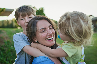 Buy stock photo Shot of a mother bonding with her two little children outdoors