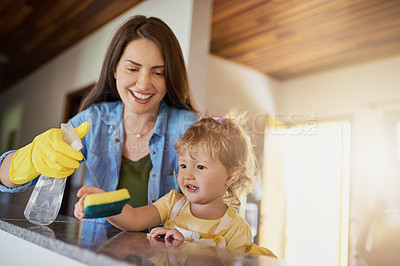 Buy stock photo Mother, kid and cleaning table with spray in home for helping hand, teaching hygiene or bonding. Family, woman or girl  child with disinfectant to wipe surface in house for bacteria or chores support