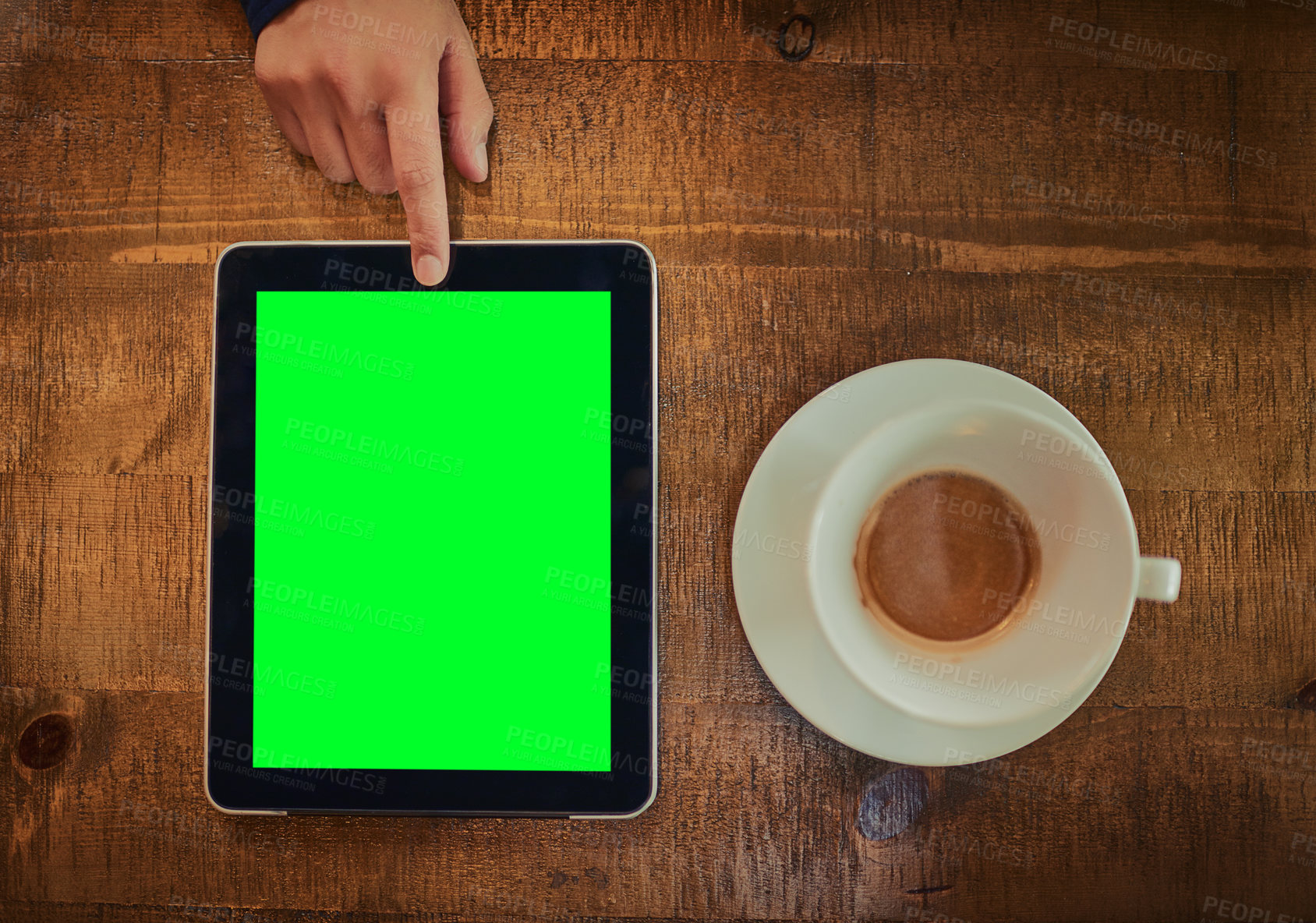 Buy stock photo High angle shot of an unrecognizable man using a digital tablet with a green screen in a cafe