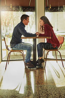 Buy stock photo Smile, couple and holding hands on date at cafe for valentines day, romantic celebration and commitment. Happy, people and support with relationship trust, loyalty and bonding together at restaurant