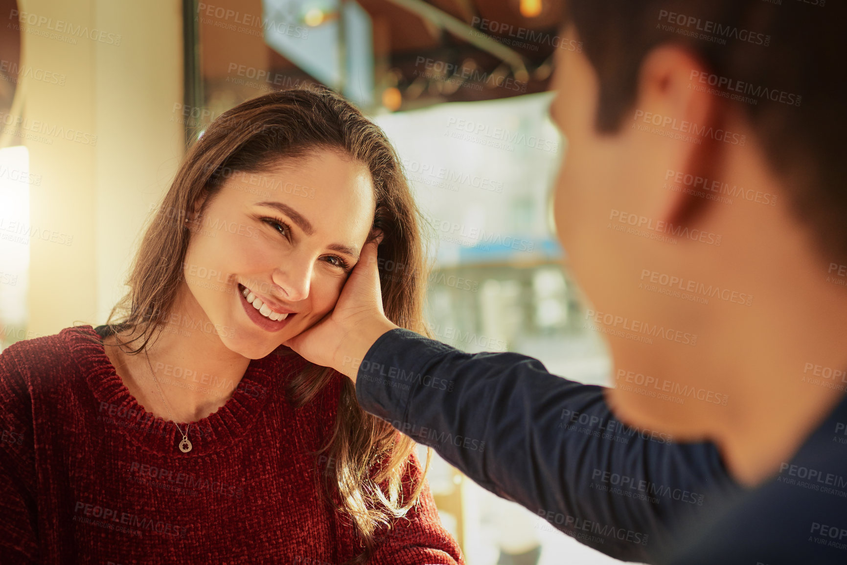 Buy stock photo Shot of a young man and woman on a romantic date at a coffee shop