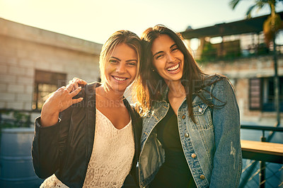 Buy stock photo Portrait of two female friends spending the day outside on a rooftop