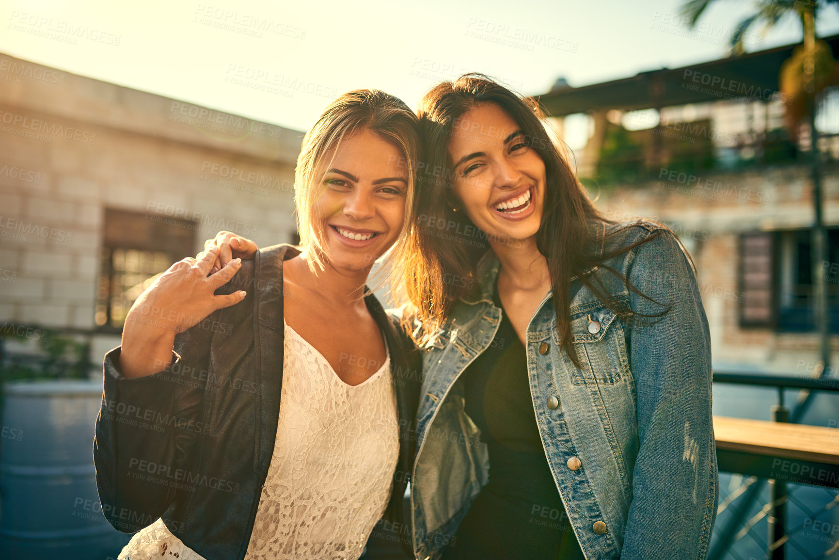 Buy stock photo Portrait of two female friends spending the day outside on a rooftop