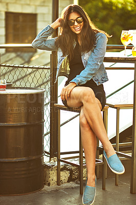 Buy stock photo Shot of an attractive young woman spending the day outside on a rooftop