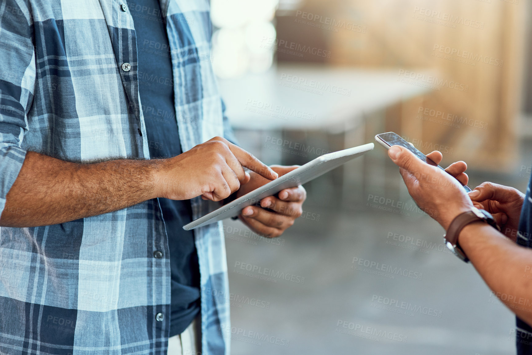 Buy stock photo Closeup shot of two unrecognizable designers using digital devices in an office