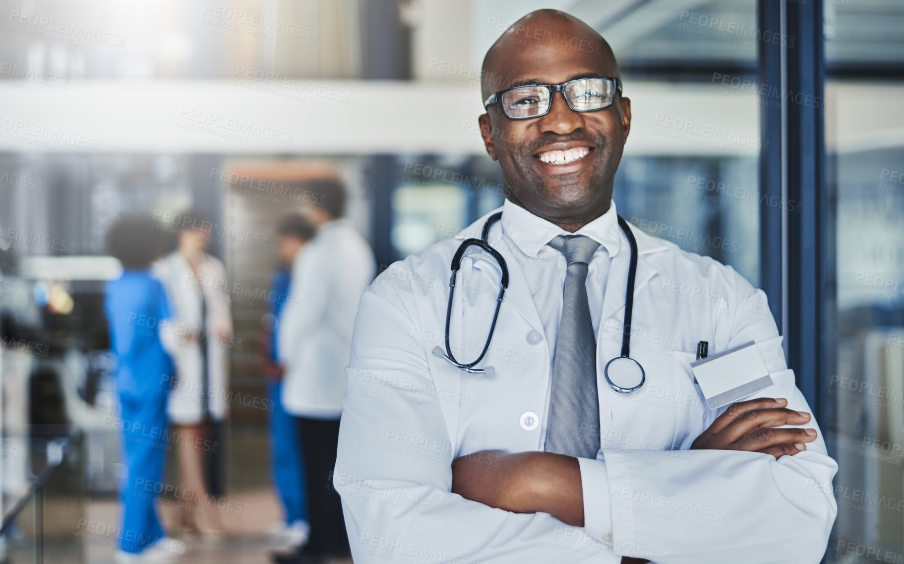 Buy stock photo Doctor, happy and confidence in hospital for healthcare, wellness or medical experience with stethoscope. Black man, smile and portrait in health facility with crossed arms for cardiology or medicine