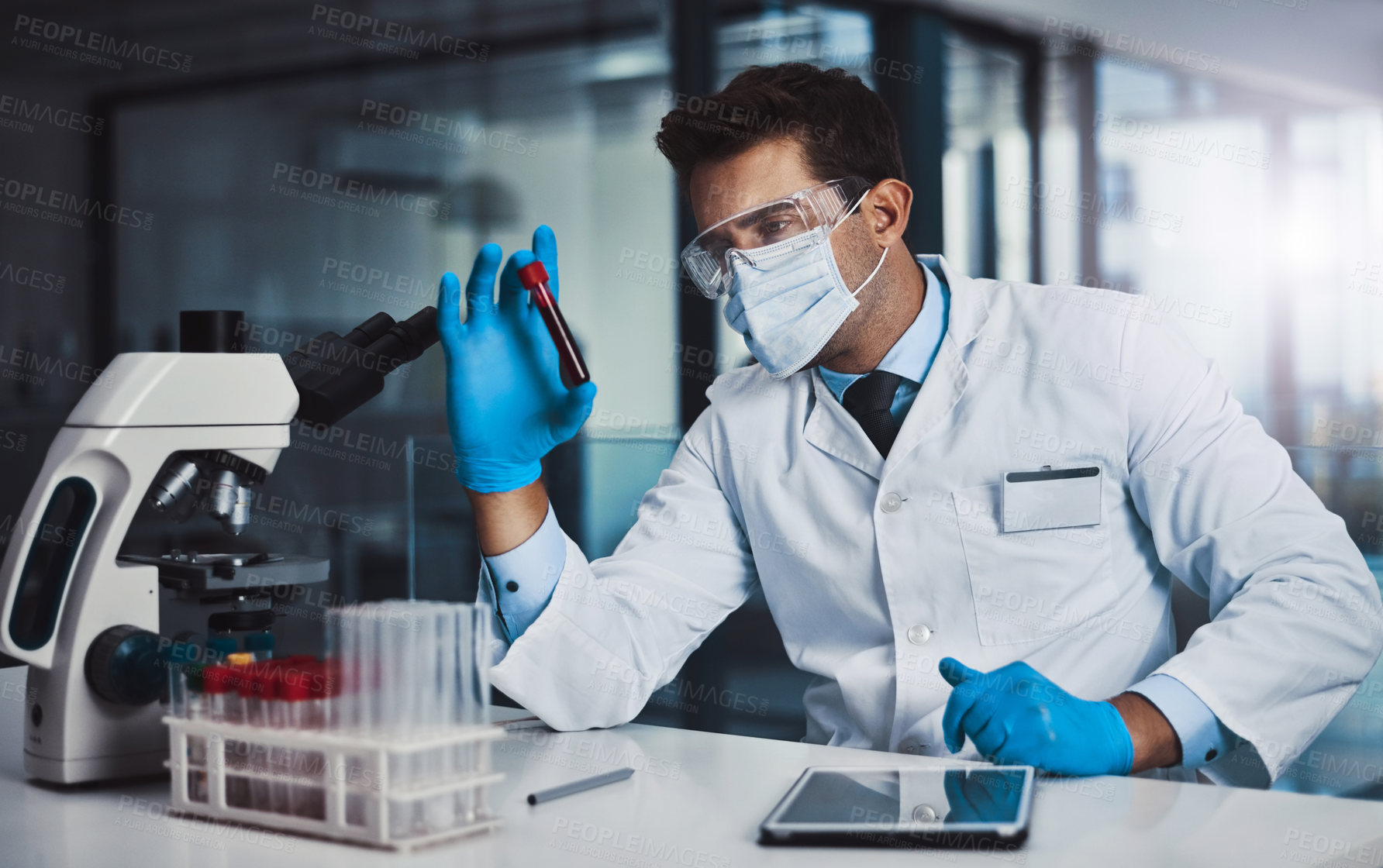 Buy stock photo Cropped shot of a young male scientist working in a lab