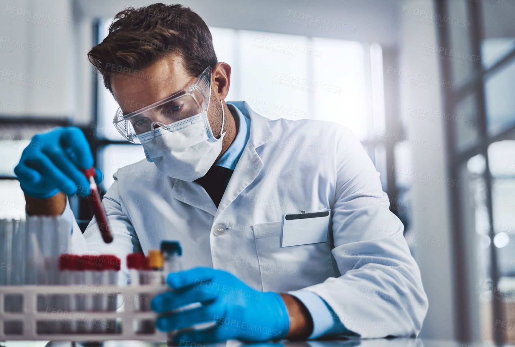 Buy stock photo Cropped shot of a young male  scientist working in a lab