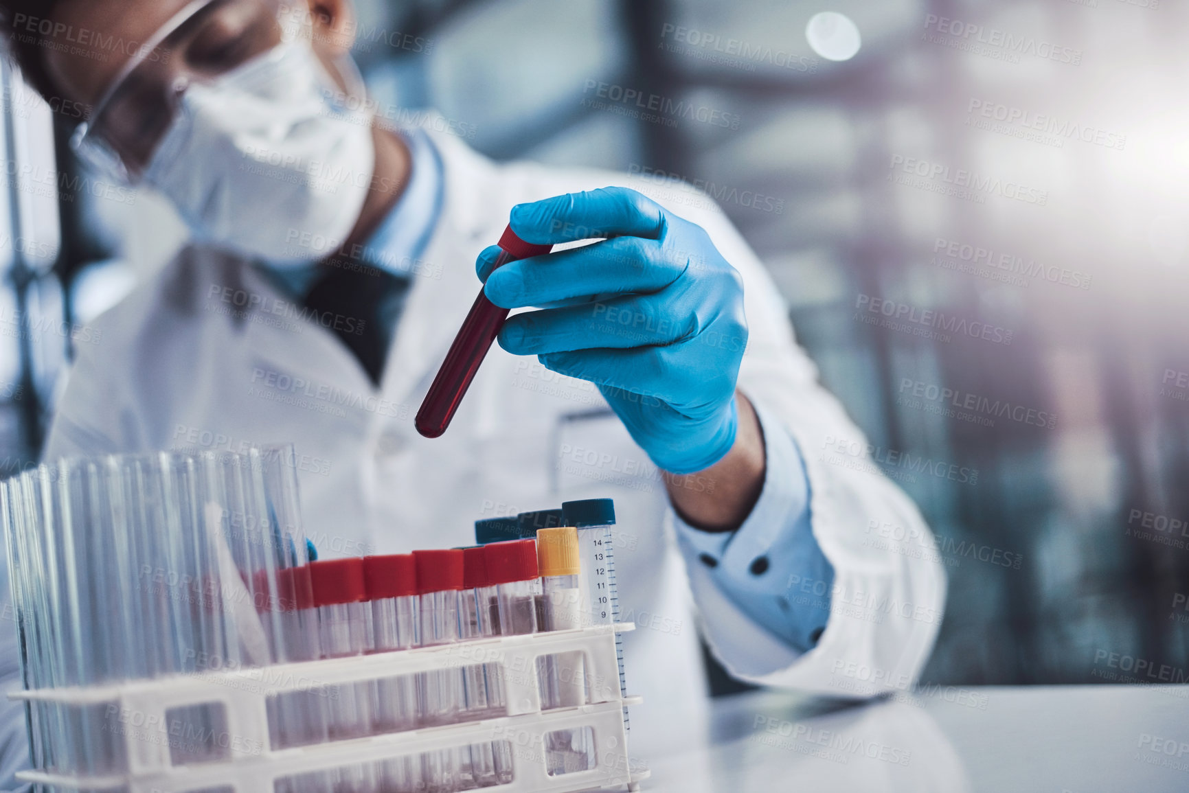 Buy stock photo Cropped shot of a young male scientist working in a lab