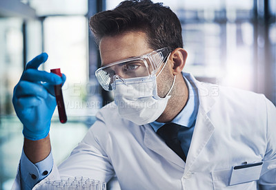 Buy stock photo Cropped shot of a young male scientist working in a lab