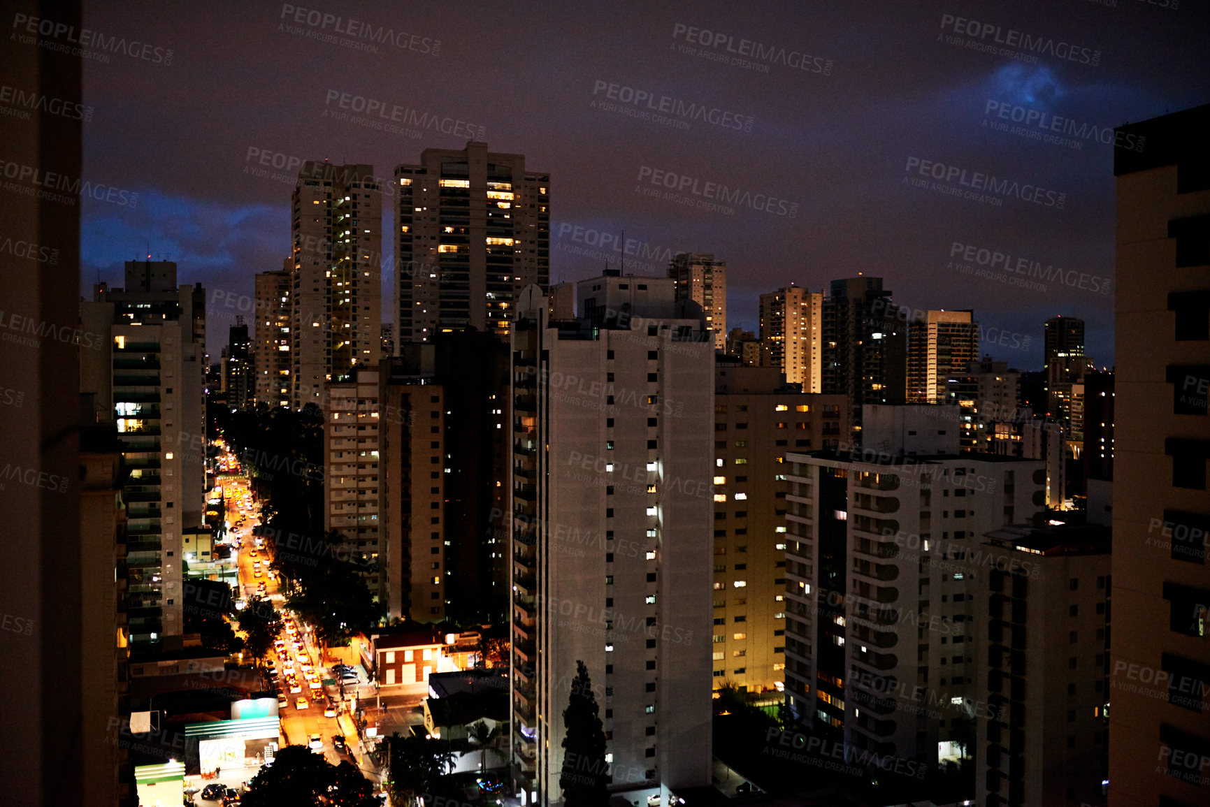 Buy stock photo Cityscape, metro and buildings at night for development, infrastructure and road for transport. Urban, lights and architecture exterior with scenery for property, facade and skyline in New York