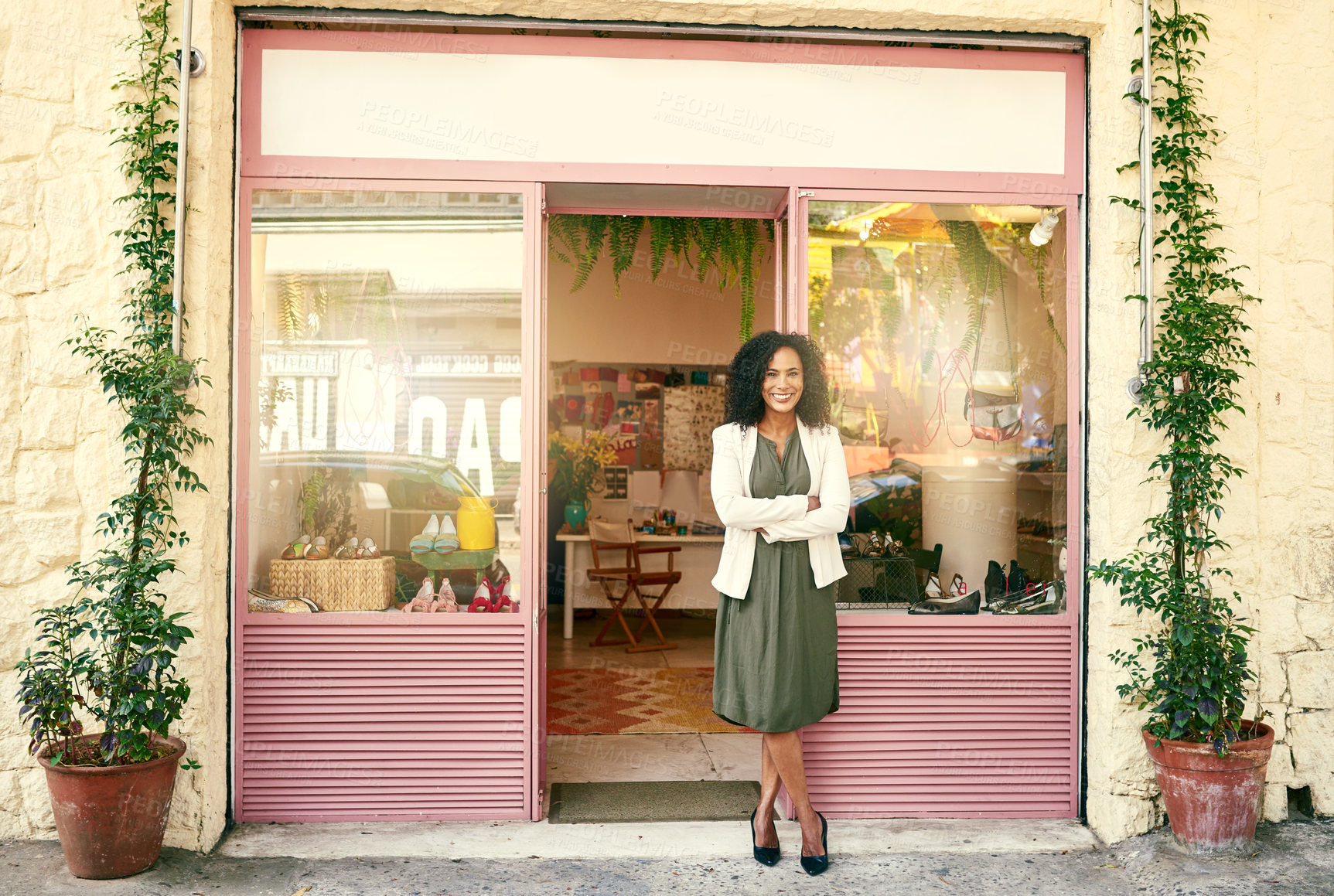 Buy stock photo Shot of a shoe shop owner standing in front of her shop