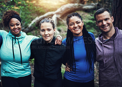 Buy stock photo Portrait of a group of sporty young friends standing in a row while working out in the forest