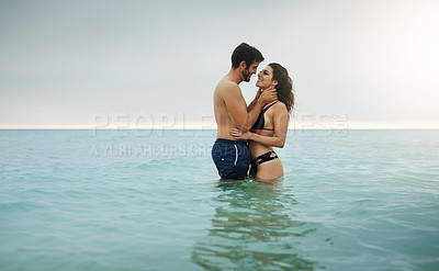 Buy stock photo Hug, water and couple in ocean with love and smile on vacation, valentines day and holiday. Tropical, eye contact and man with woman or embrace for bonding together at sea for romantic trip on island