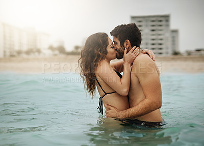 Buy stock photo Shot of an affectionate couple spending some time in the water