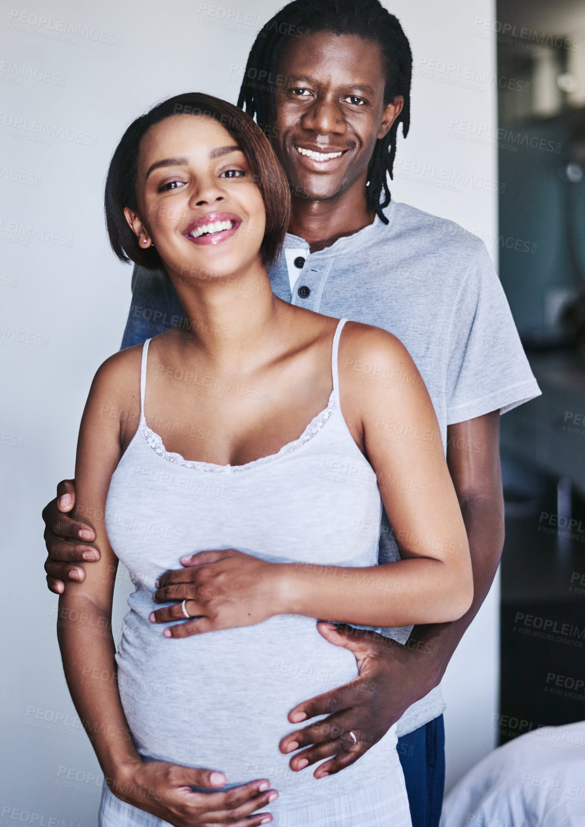 Buy stock photo Cropped shot of a young expecting couple at home