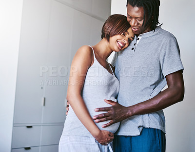 Buy stock photo Happy couple, pregnant and parenthood with belly or baby bump for maternity or expecting at home. Black man and young woman with smile for hug, love or support on healthy pregnancy or care at house