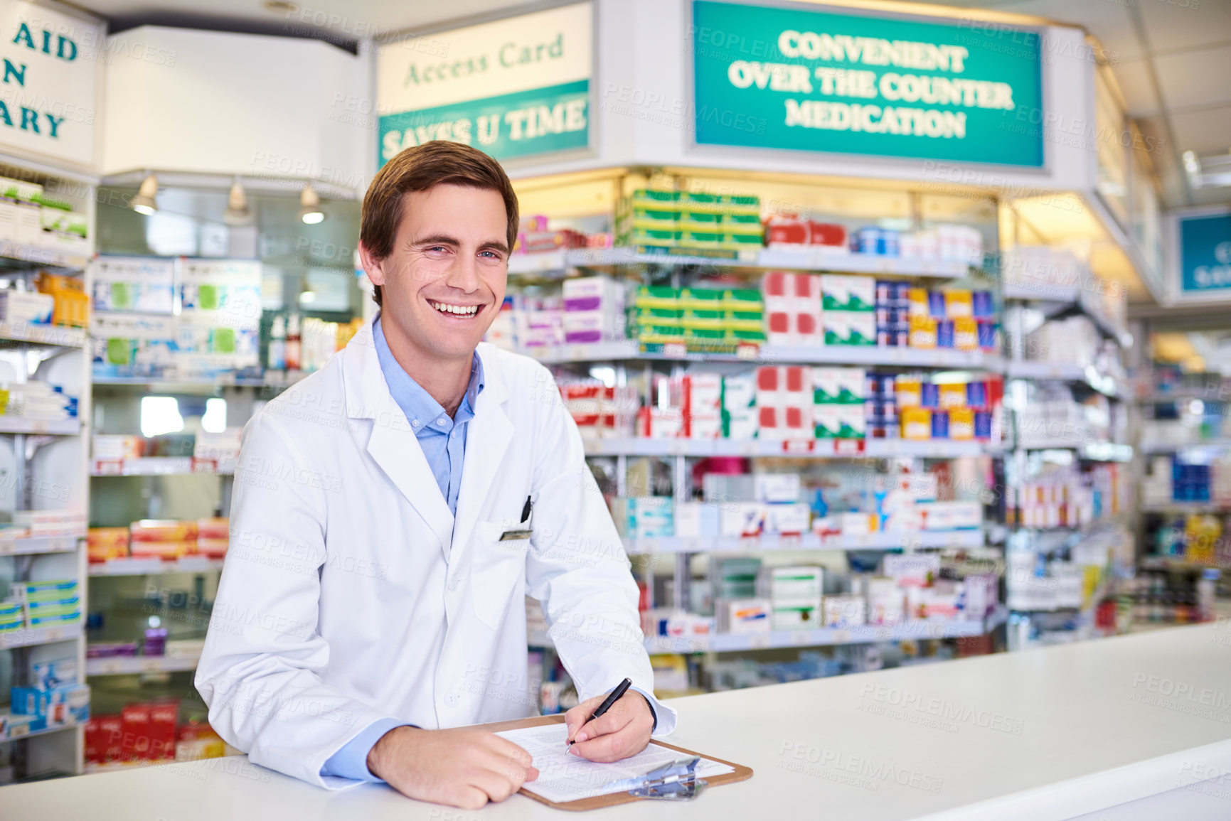 Buy stock photo Portrait of a young pharmacist writing on a clipboard in a chemist