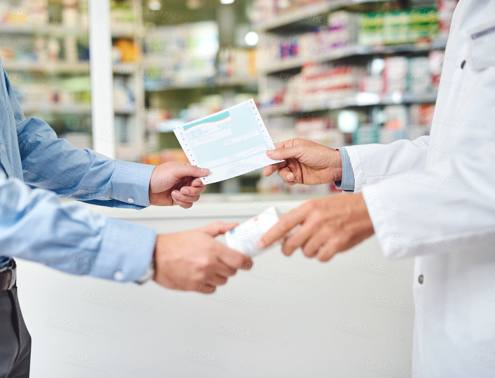 Buy stock photo Cropped shot of an unrecognizable male pharmacist helping a customer in the pharmacy