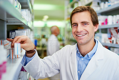 Buy stock photo Portrait of a young pharmacist doing inventory in a pharmacy