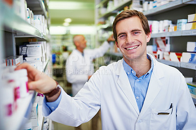 Buy stock photo Portrait of a young pharmacist doing inventory in a pharmacy