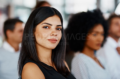 Buy stock photo Cropped portrait of an attractive young businesswoman sitting in the conference room during a seminar