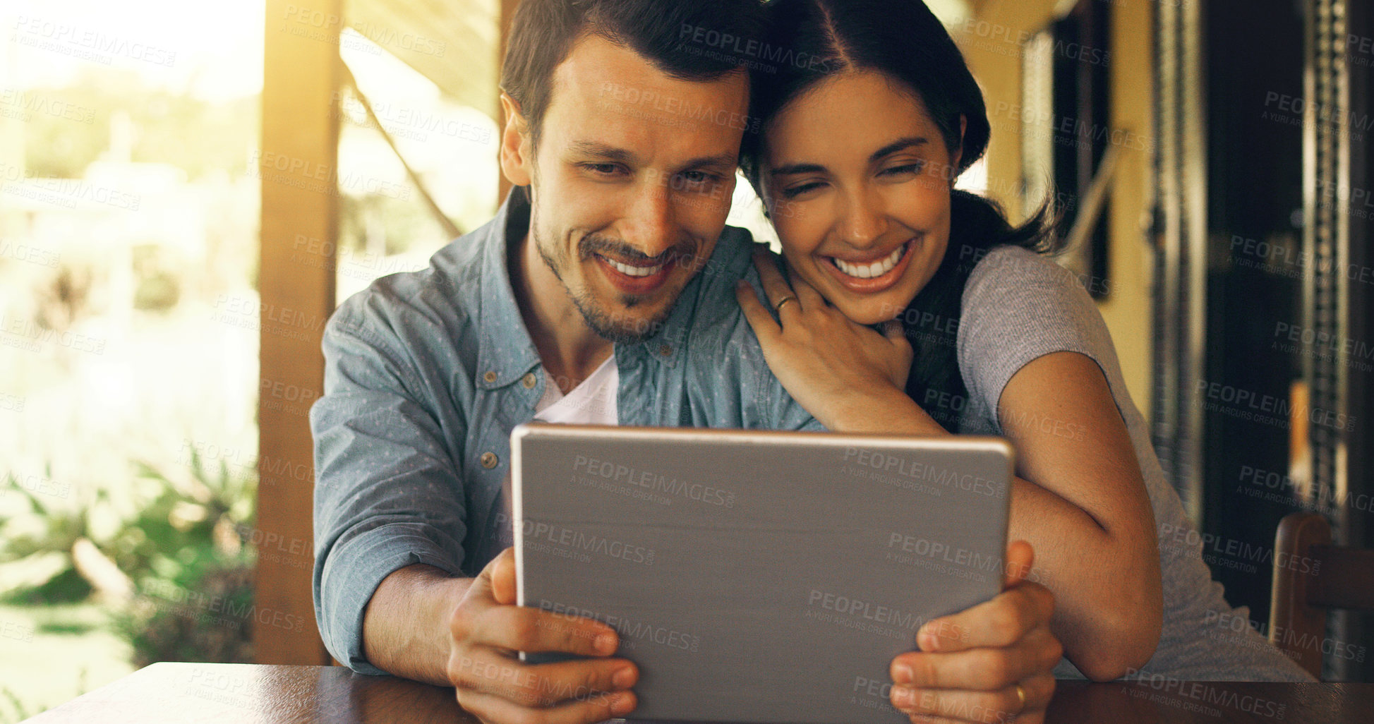 Buy stock photo Cropped shot of a young attractive couple using a tablet at home 