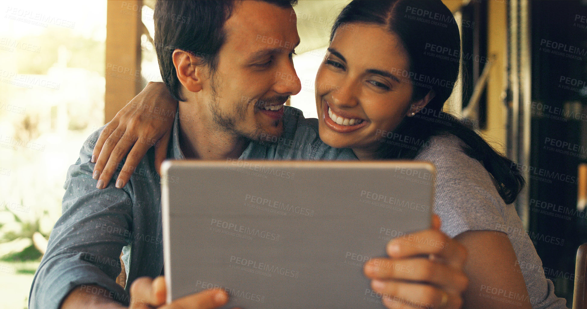 Buy stock photo Cropped shot of a young attractive couple using a tablet at home 
