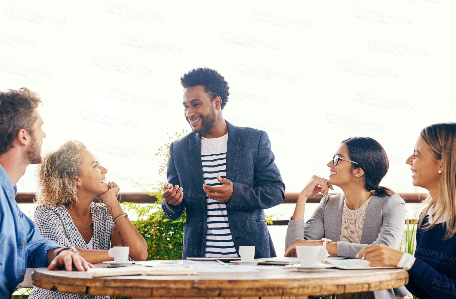 Buy stock photo Shot of a group of businesspeople having a meeting outdoors