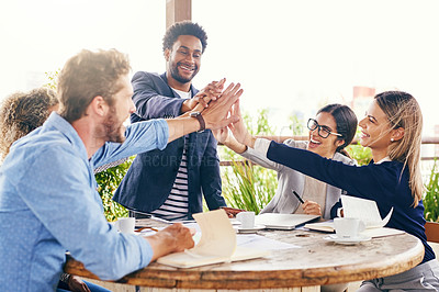 Buy stock photo Shot of a group of businesspeople high fiving during a meeting outdoors
