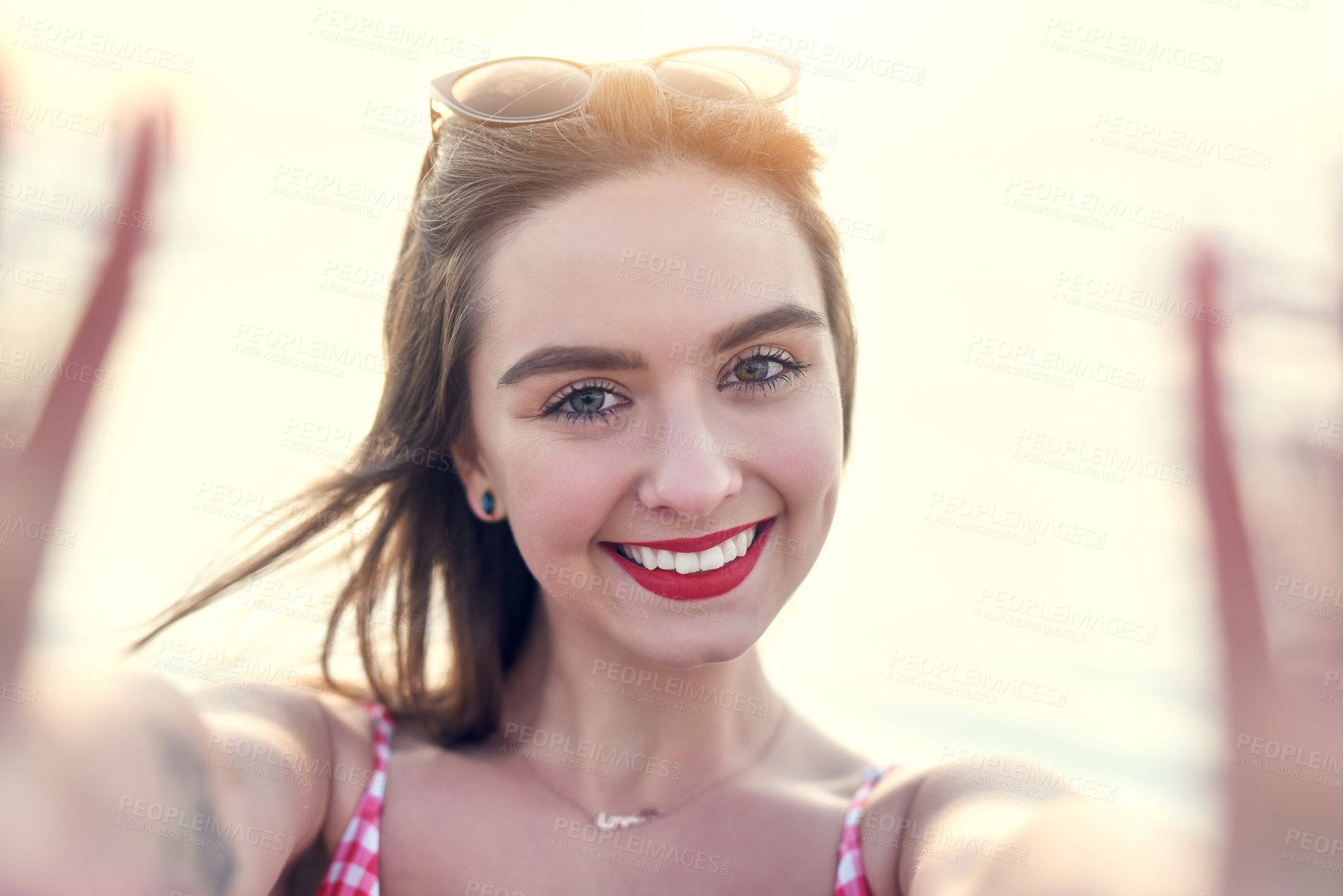 Buy stock photo Portrait of a beautiful young woman taking a selfie at the beach