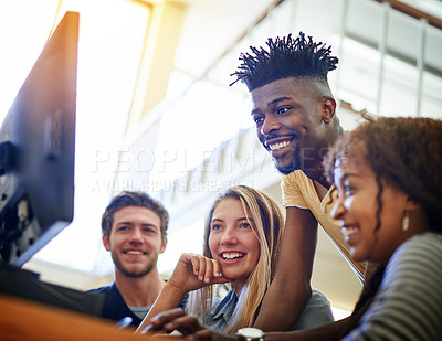 Buy stock photo Shot of a group of university students working together on a computer in the library at campus