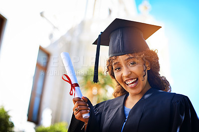 Buy stock photo Cropped shot of a happy young woman holding her certificate on graduation day