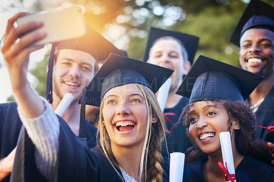 Buy stock photo Cropped shot of a group of university students taking a selfie on graduation day