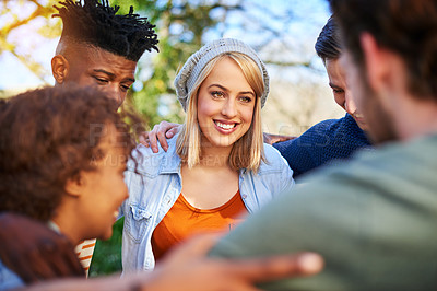 Buy stock photo Cropped shot of a group of students hanging out together outside on campus