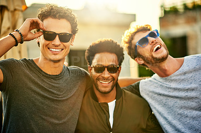Buy stock photo Shot of a group of young men hanging out together outdoors