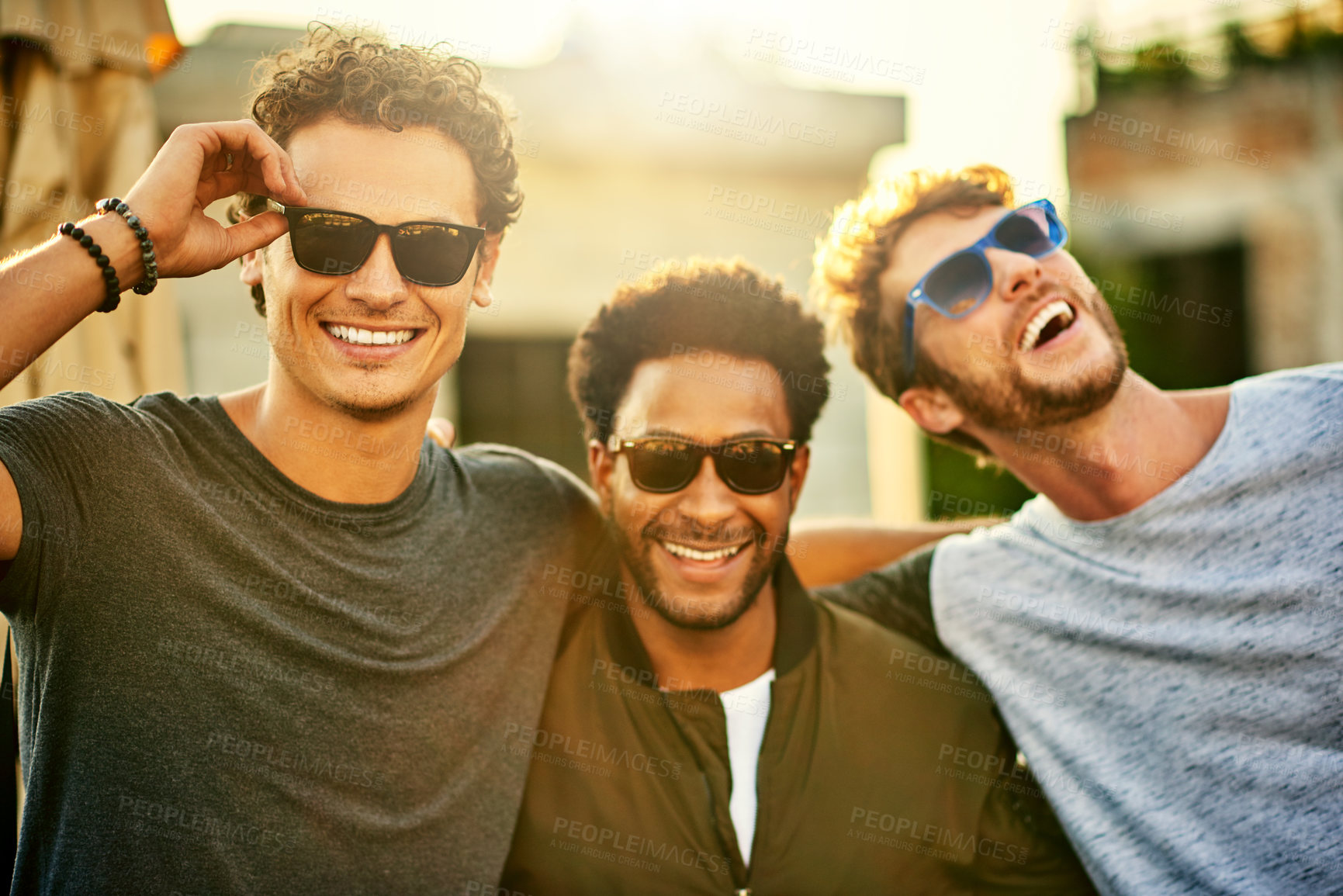 Buy stock photo Shot of a group of young men hanging out together outdoors