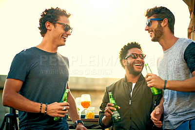 Buy stock photo Shot of a group of young friends hanging out and having drinks together outdoors