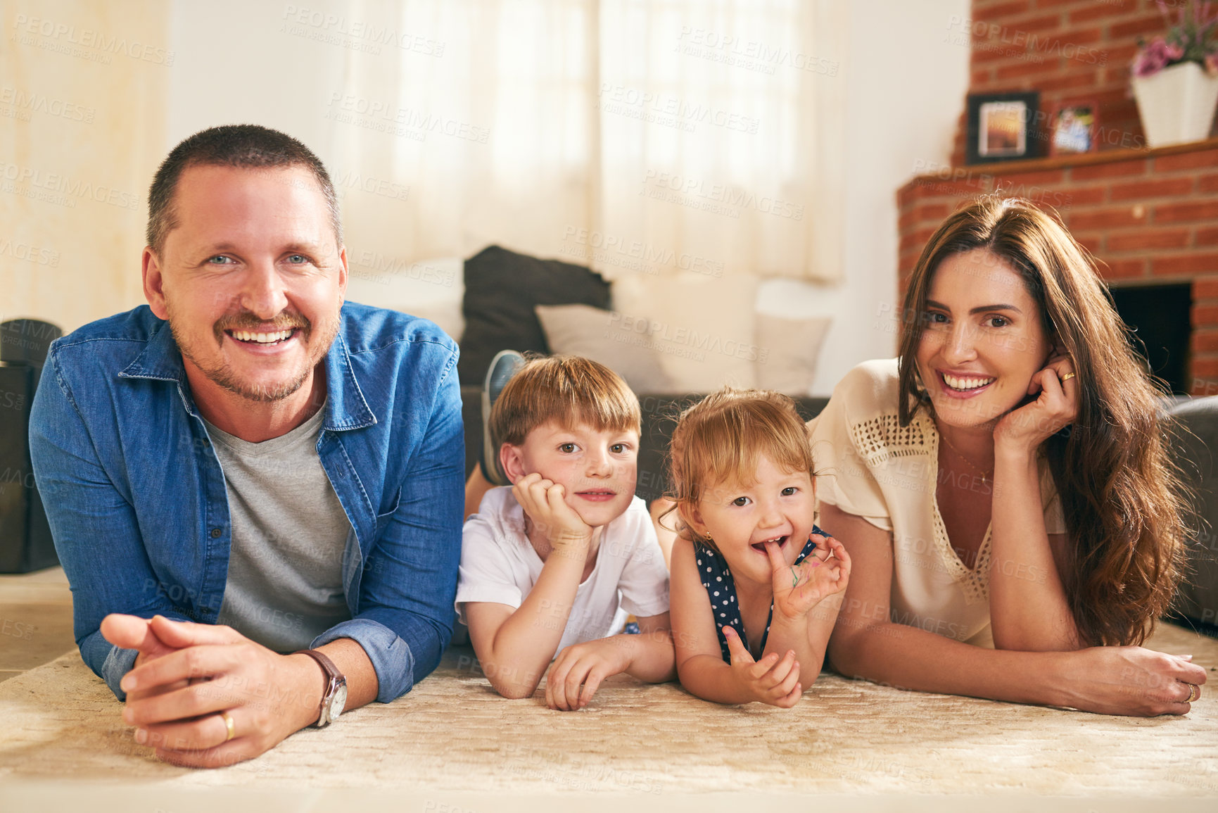 Buy stock photo Portrait of a happy young family spending quality time together at at home